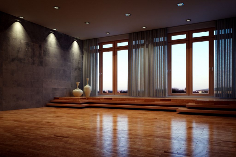 Elegancki salon z dużymi oknami i drewnianą podłogą.